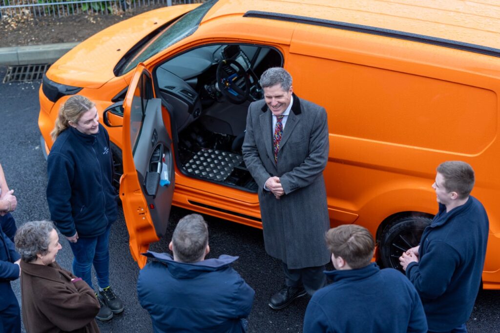 Transport minister hears from apprentices about their vividly coloured ford transit connect development vehicle - un nouveau laboratoire d’essais de véhicules électriques ford